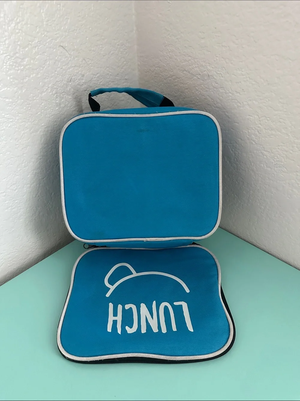 Walmart blue insulated lunch box with a minimalist white ’LUNCH’ graphic-used